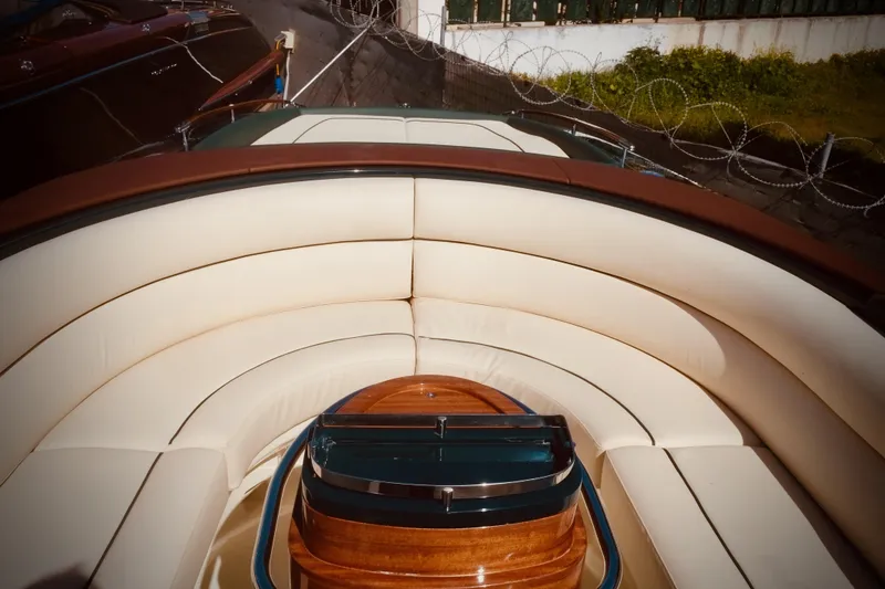  Yacht Photos Pics Luxurious 2003 Riva Aquariva 33 boat interior with elegant cream seating and polished wood accents.