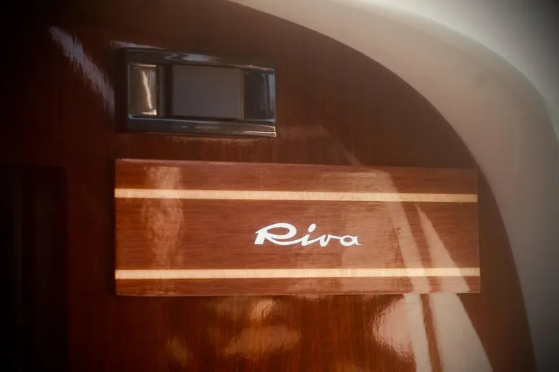 Yacht Photos Pics Riva Aquariva 33, 2003 model, elegant wooden panel with logo detail.