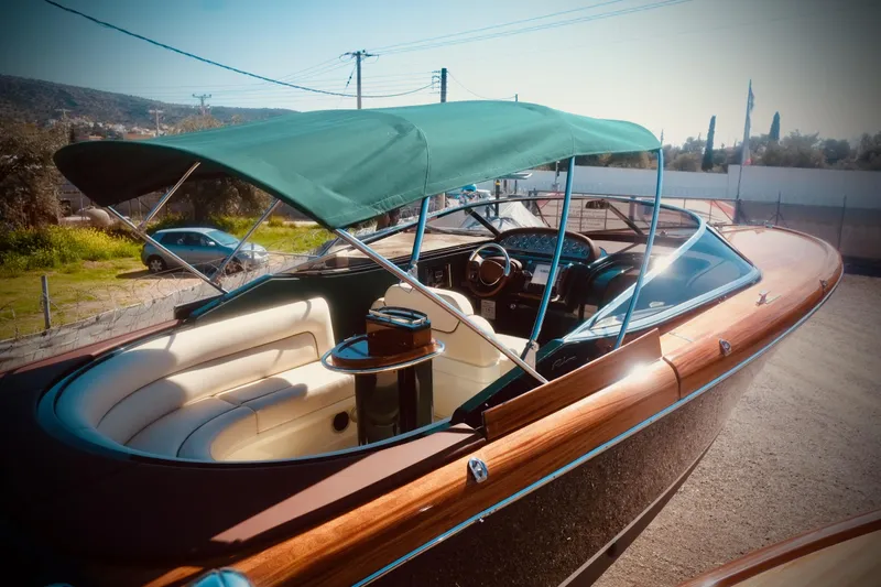  Yacht Photos Pics 2003 Riva Aquariva 33 boat with green canopy and luxurious interior.