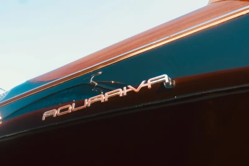  Yacht Photos Pics 2003 Riva Aquariva 33 boat nameplate on sleek, polished hull.