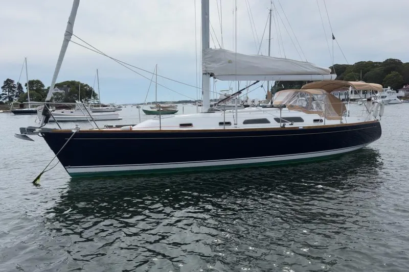 Finesse Yacht Photos Pics 2005 Sabre 386 sailboat anchored in a calm harbor, featuring sleek design and white sails.