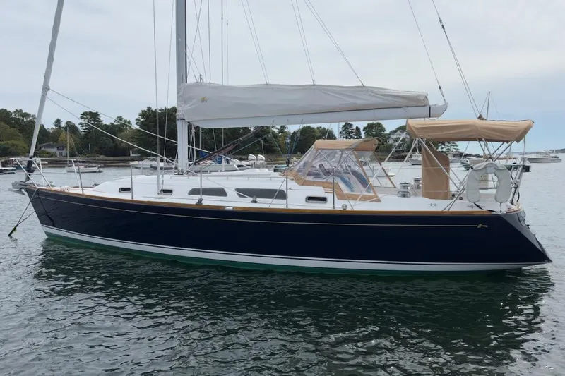 Finesse Yacht Photos Pics 2005 Sabre 386 sailboat on calm water, featuring sleek design and white sails.