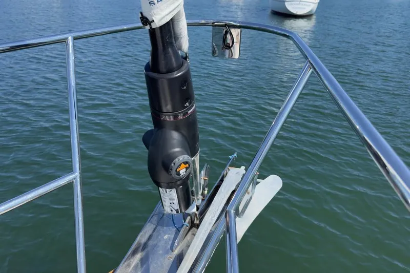 Finesse Yacht Photos Pics Bow of 2005 Sabre 386 sailboat with anchor and railing over water.