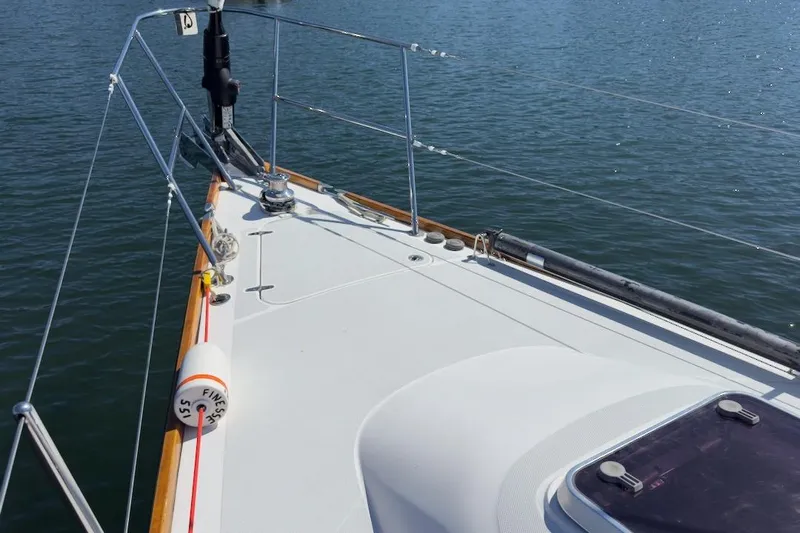 Finesse Yacht Photos Pics Bow of 2005 Sabre 386 sailboat on calm water, featuring deck details and railing.