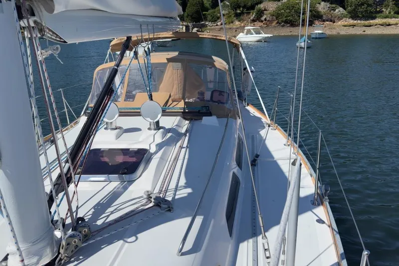 Finesse Yacht Photos Pics 2005 Sabre 386 sailboat on calm water, featuring deck and rigging details.