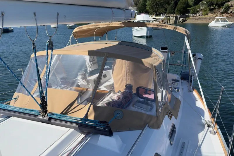 Finesse Yacht Photos Pics Sailboat Sabre 386, 2005 model, anchored in a serene bay with clear skies.