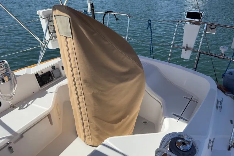 Finesse Yacht Photos Pics 2005 Sabre 386 sailboat cockpit with covered equipment, moored on calm water.