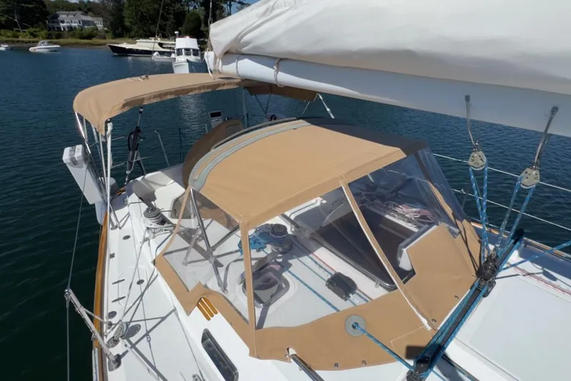 Finesse Yacht Photos Pics 2005 Sabre 386 sailboat with tan canopy, docked in a serene marina.