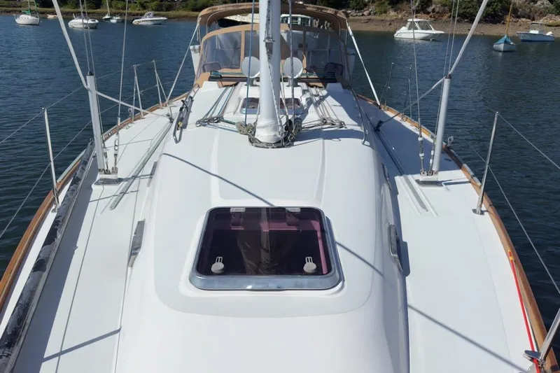 Finesse Yacht Photos Pics 2005 Sabre 386 sailboat deck view with rigging, anchored in a serene harbor.