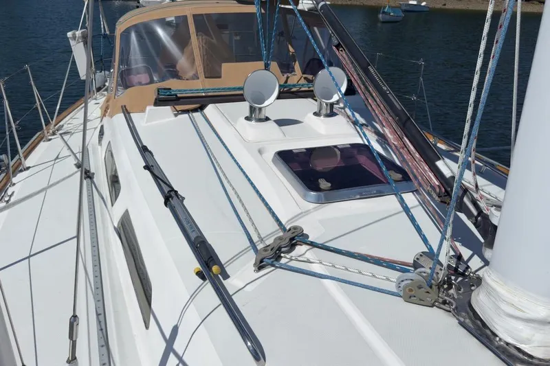 Finesse Yacht Photos Pics 2005 Sabre 386 sailboat deck with rigging and hatch, docked on calm water.