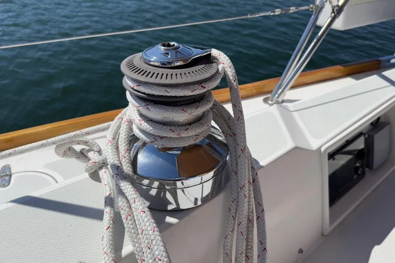 Finesse Yacht Photos Pics Winch with rope on 2005 Sabre 386 sailboat deck, overlooking water.