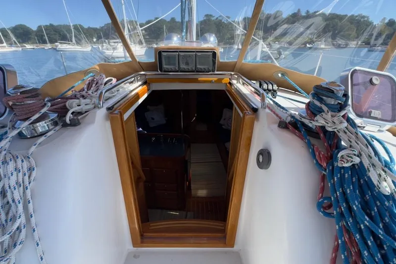 Finesse Yacht Photos Pics Cockpit view of 2005 Sabre 386 sailboat with ropes and open cabin door.