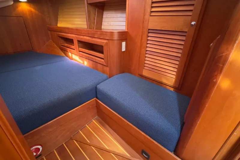 Finesse Yacht Photos Pics Cozy cabin interior of 2005 Sabre 386 yacht with blue cushions and wooden finish.