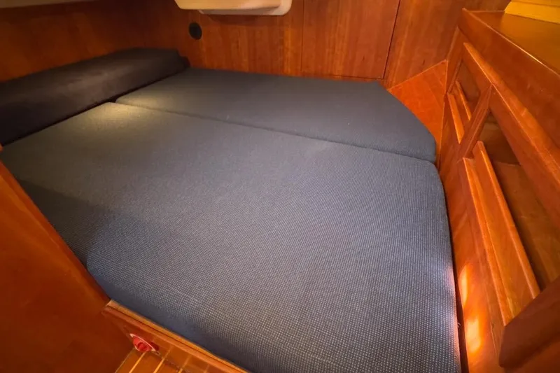 Finesse Yacht Photos Pics Interior cabin of 2005 Sabre 386 yacht with blue bedding and wooden finish.