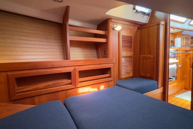 Finesse Yacht Photos Pics Luxurious 2005 Sabre 386 yacht interior with wooden cabinetry and blue upholstery.
