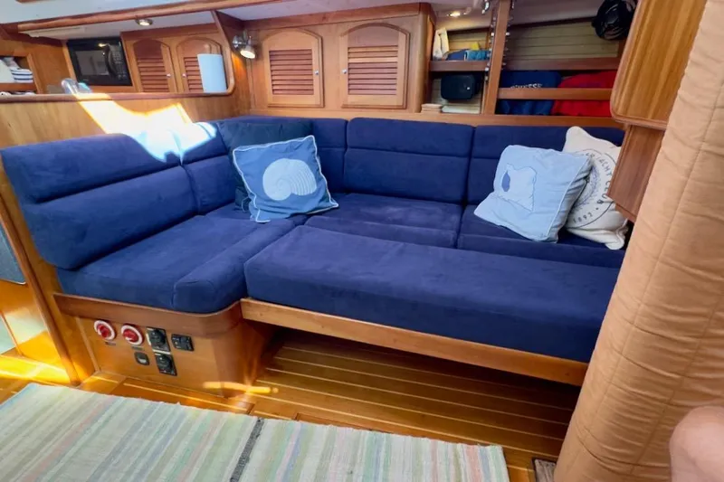 Finesse Yacht Photos Pics Cozy interior of 2005 Sabre 386 yacht with blue cushioned seating and nautical decor.