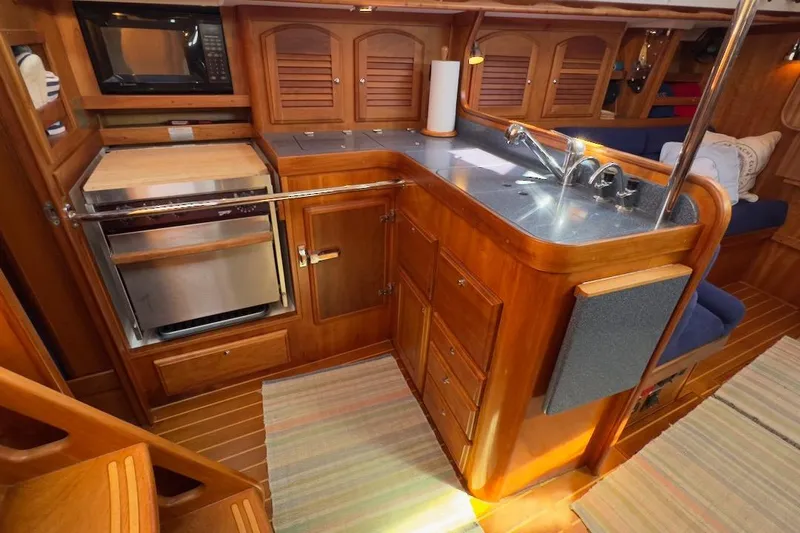 Finesse Yacht Photos Pics 2005 Sabre 386 yacht interior kitchen with wood cabinetry and modern appliances.