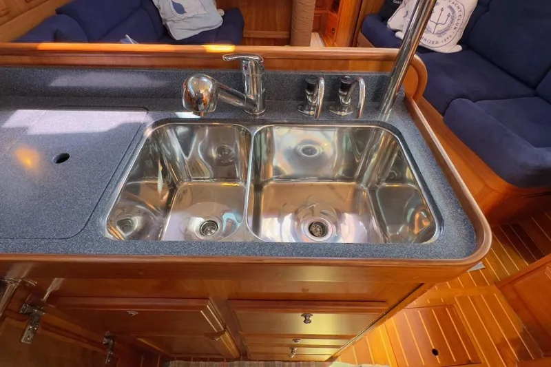 Finesse Yacht Photos Pics Stainless steel sink in 2005 Sabre 386 yacht kitchen with wooden cabinetry.