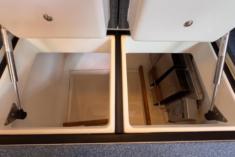 Finesse Yacht Photos Pics Open storage compartments on a 2005 Sabre 386 boat, featuring hydraulic lifts.