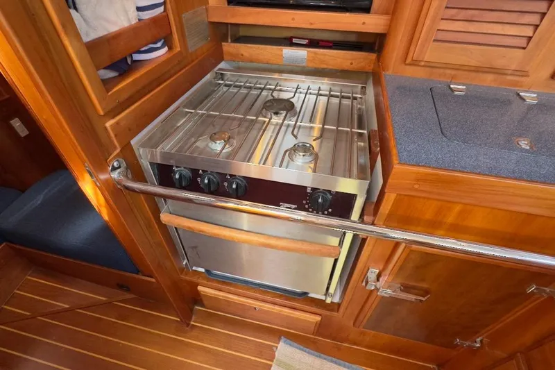 Finesse Yacht Photos Pics Wooden yacht kitchen with stainless steel stove, Sabre 386, 2005 model.
