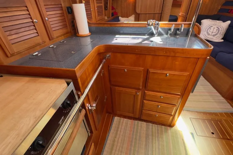 Finesse Yacht Photos Pics Interior of 2005 Sabre 386 yacht featuring a wooden galley with stove and sink.