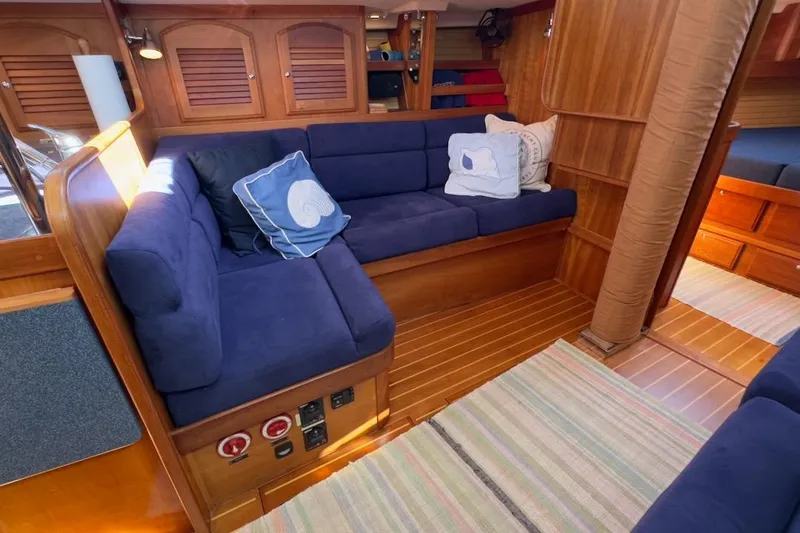 Finesse Yacht Photos Pics Interior of 2005 Sabre 386 yacht with blue cushioned seating and wooden finish.