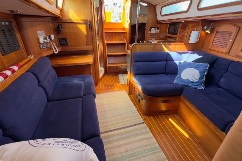 Finesse Yacht Photos Pics Luxurious 2005 Sabre 386 yacht interior with blue seating and wooden accents.