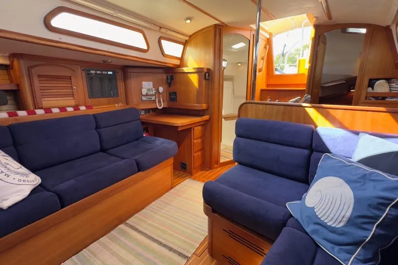Finesse Yacht Photos Pics Interior of 2005 Sabre 386 yacht with blue seating and wooden finishes.