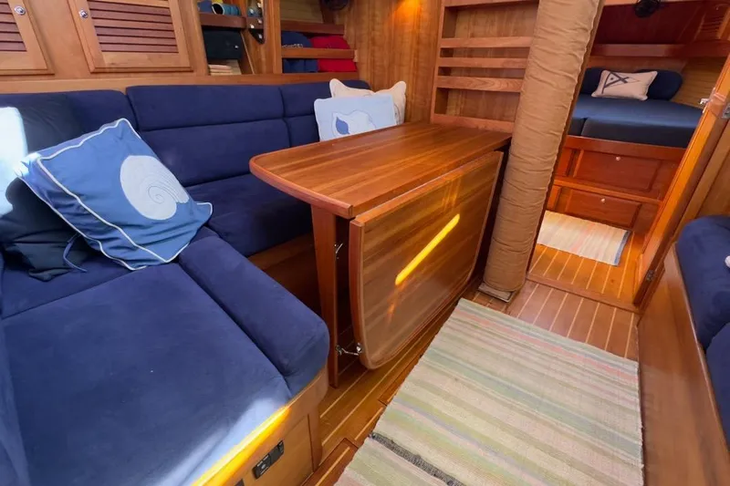 Finesse Yacht Photos Pics Interior of 2005 Sabre 386 yacht with cozy seating and wooden table.