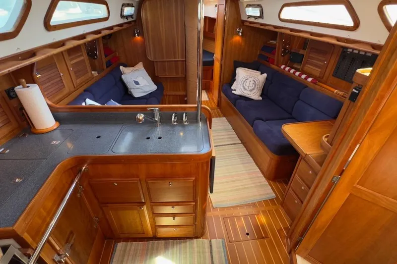 Finesse Yacht Photos Pics Interior of 2005 Sabre 386 yacht with wooden cabinetry and blue seating.