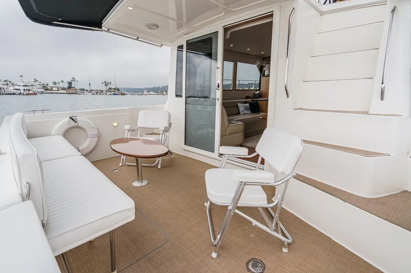 Carrin G Yacht Photos Pics 2008 Navigator 4600 Pilothouse yacht deck with seating, table, and ocean view.