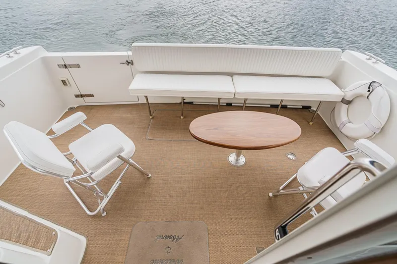 Carrin G Yacht Photos Pics 2008 Navigator 4600 Pilothouse yacht deck with seating, table, and life preserver.