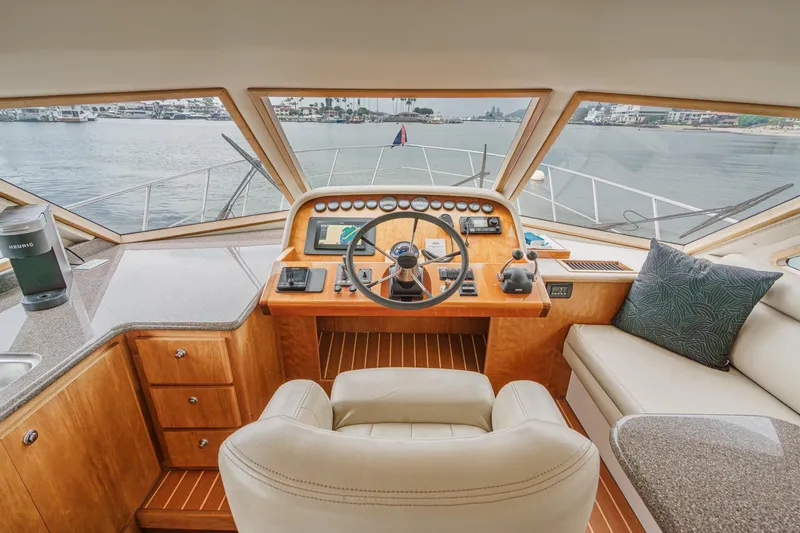 Carrin G Yacht Photos Pics Pilothouse interior of 2008 Navigator 4600 yacht with steering wheel and navigation equipment.