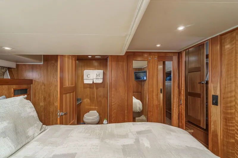 Carrin G Yacht Photos Pics Luxurious 2008 Navigator 4600 Pilothouse yacht interior with wood paneling and cozy bedroom.