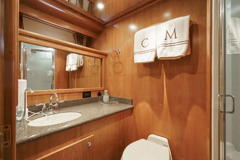 Carrin G Yacht Photos Pics Luxurious bathroom in 2008 Navigator 4600 Pilothouse yacht with wood paneling and elegant fixtures.