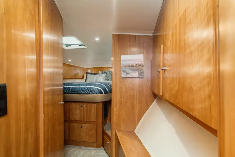 Carrin G Yacht Photos Pics Luxurious 2008 Navigator 4600 Pilothouse cabin with wood finish and cozy bedding.