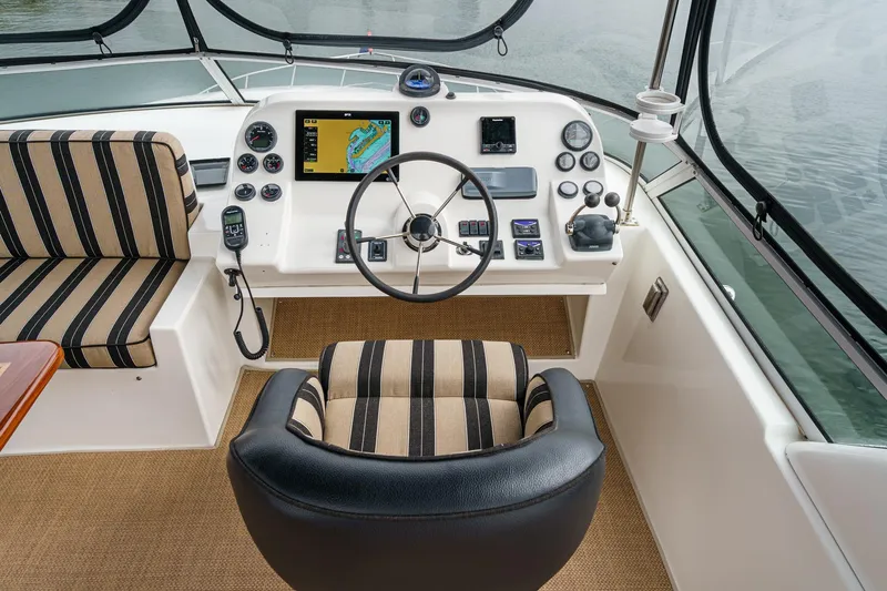 Carrin G Yacht Photos Pics Pilothouse interior of 2008 Navigator 4600, featuring striped seating and navigation controls.