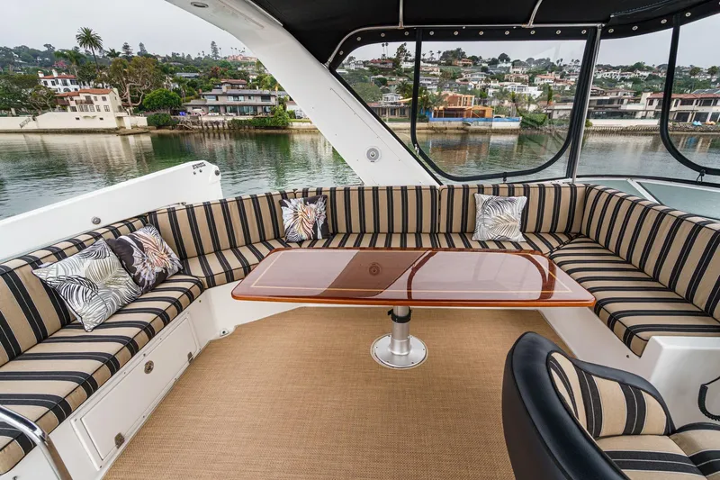 Carrin G Yacht Photos Pics Luxurious 2008 Navigator 4600 Pilothouse yacht interior with striped seating and elegant table.