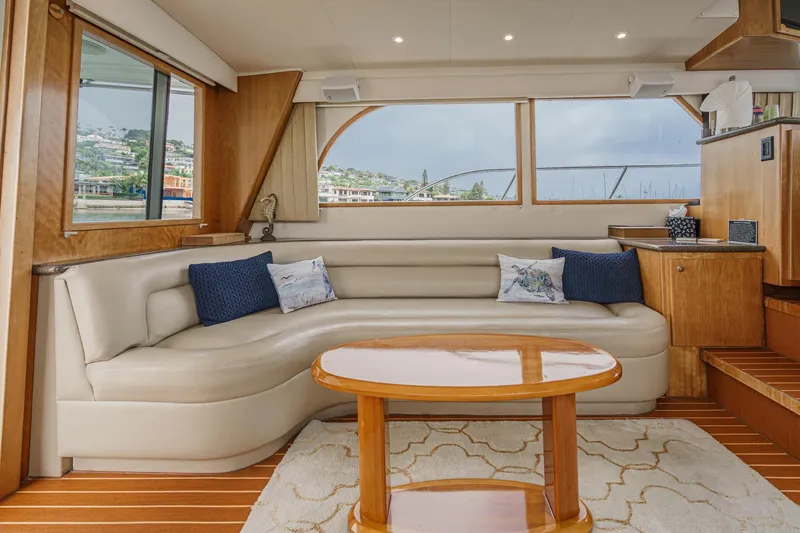 Carrin G Yacht Photos Pics Luxurious interior of 2008 Navigator 4600 Pilothouse yacht with elegant seating and wooden accents.