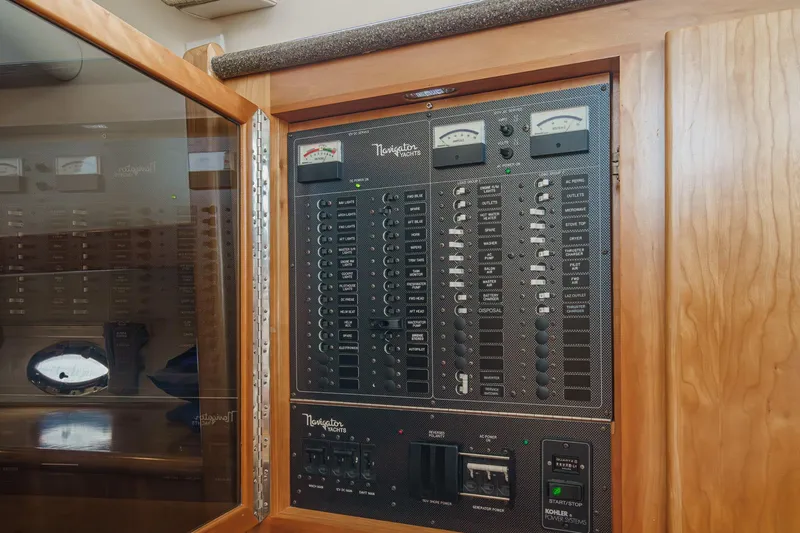 Carrin G Yacht Photos Pics Electrical panel of 2008 Navigator 4600 Pilothouse yacht with various switches and gauges.