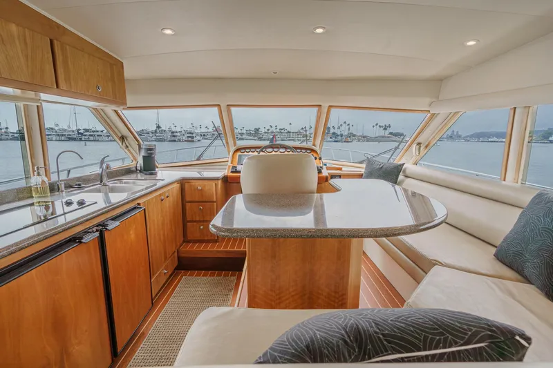 Carrin G Yacht Photos Pics Luxurious interior of 2008 Navigator 4600 Pilothouse yacht with panoramic windows and elegant seating.