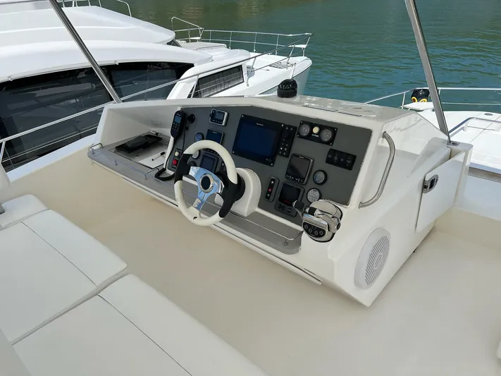 Jamsam Yacht Photos Pics Helm of 2017 Leopard 51 Powercat with modern navigation controls and steering wheel.
