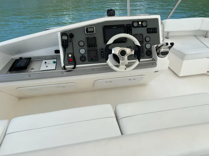 Jamsam Yacht Photos Pics Control panel of a 2017 Leopard 51 Powercat yacht with steering wheel and navigation instruments.