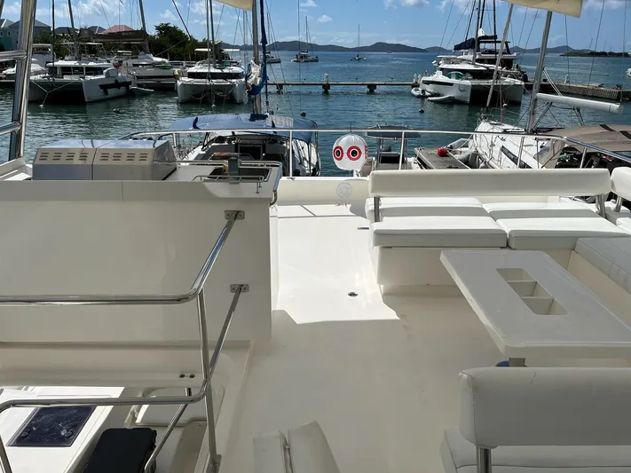 Jamsam Yacht Photos Pics Leopard 51 Powercat 2017 yacht interior with marina view, featuring seating and table.