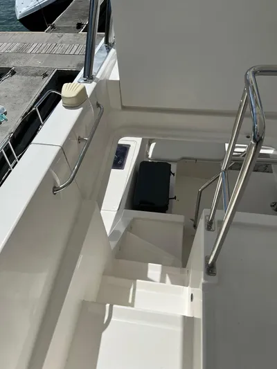 Jamsam Yacht Photos Pics 2017 Leopard 51 Powercat yacht stairs with stainless steel railings and dock view.