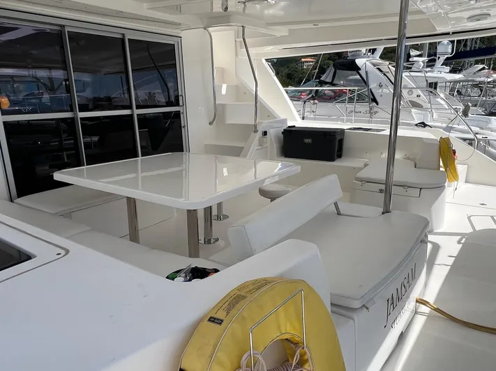 Jamsam Yacht Photos Pics 2017 Leopard 51 Powercat yacht deck with seating and table, featuring modern design and amenities.