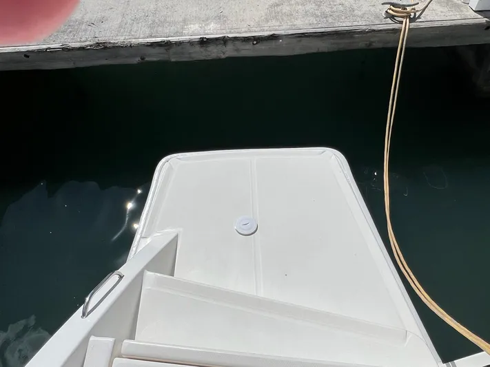 Jamsam Yacht Photos Pics Stern view of 2017 Leopard 51 Powercat at dock, showing swim platform and water.