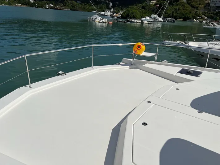 Jamsam Yacht Photos Pics 2017 Leopard 51 Powercat deck overlooking calm waters and distant boats.