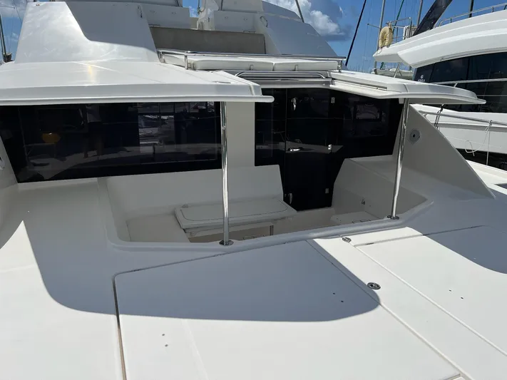 Jamsam Yacht Photos Pics 2017 Leopard 51 Powercat yacht with spacious deck and sleek design under clear skies.