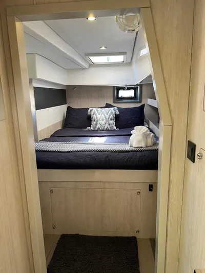 Jamsam Yacht Photos Pics 2017 Leopard 51 Powercat cabin with cozy bed, modern decor, and natural light.